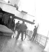 Crew members of Erin on deck in a heavy swell. October 1899.